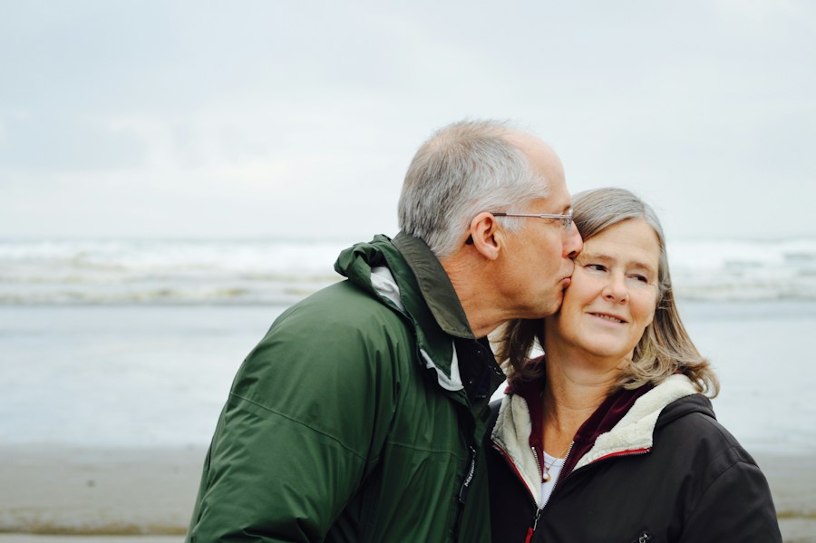 Smiling older couple embracing by the sea
